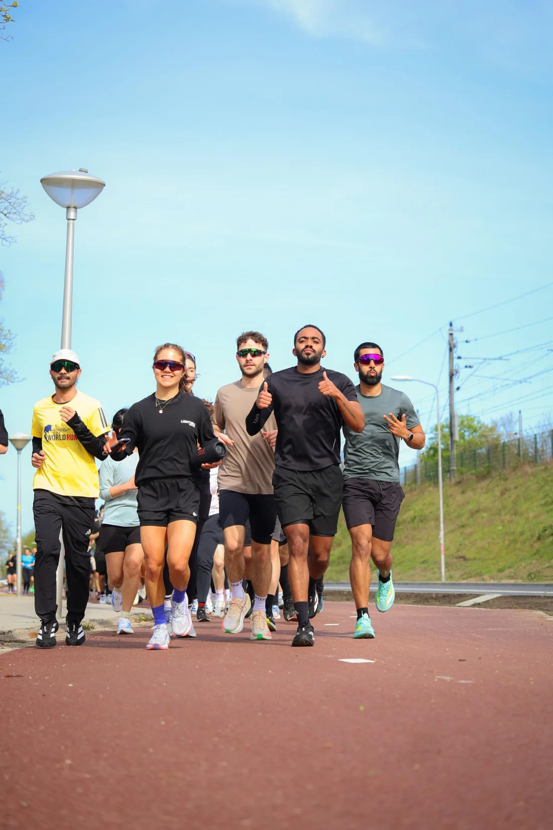 The Lightmile crew running together toward the camera under a blue sky